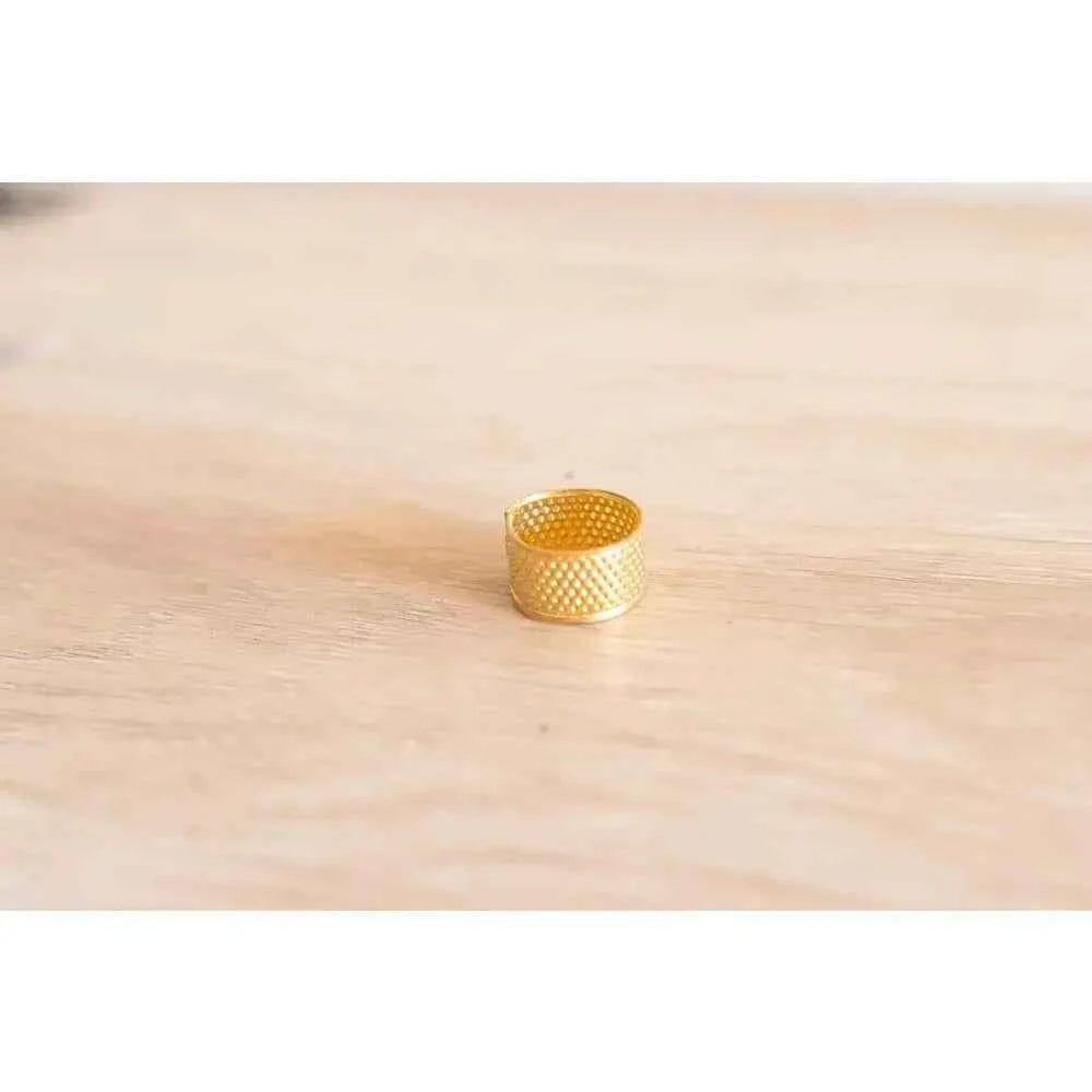 Gold thimble for precise stitching in a book binding sewing set by The Create Studio