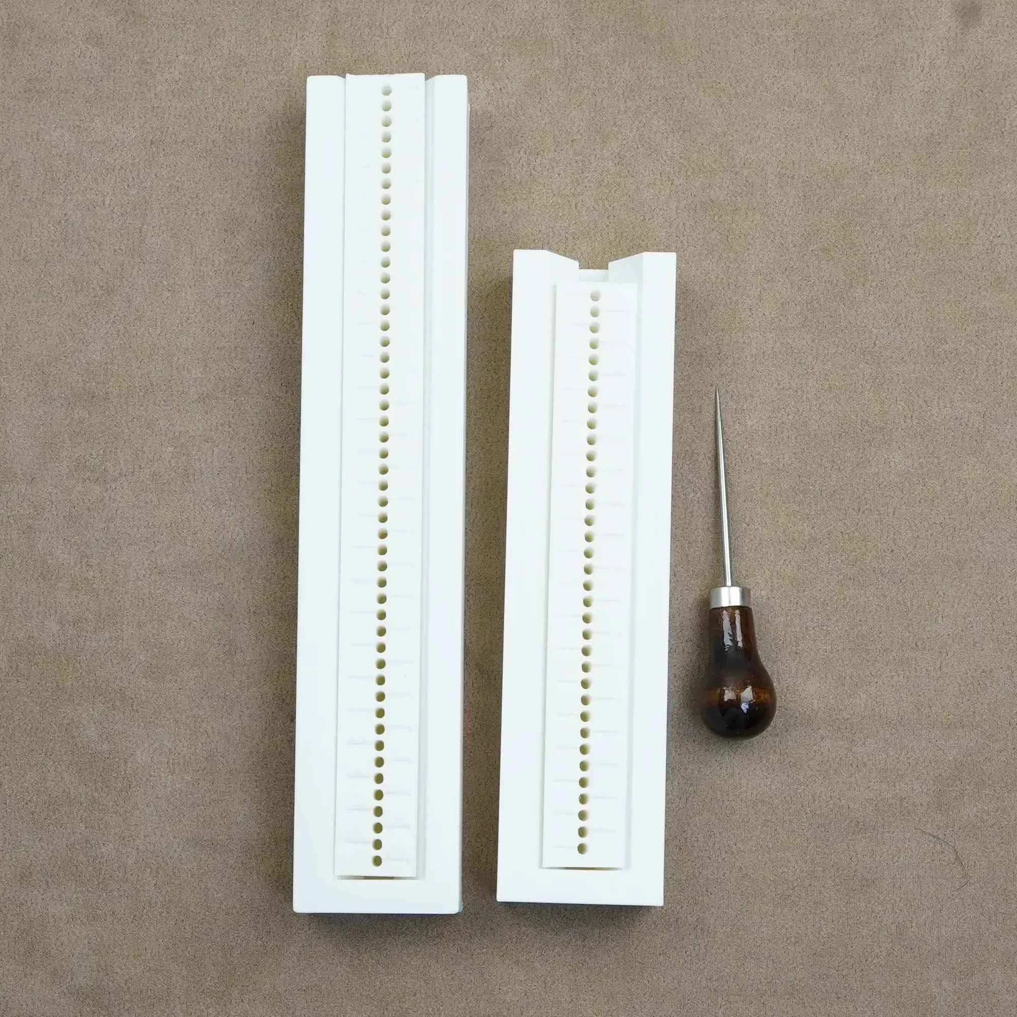 The Create Studio bookbinding hole guide set with two sizes and a stitching tool for precise bookbinding.