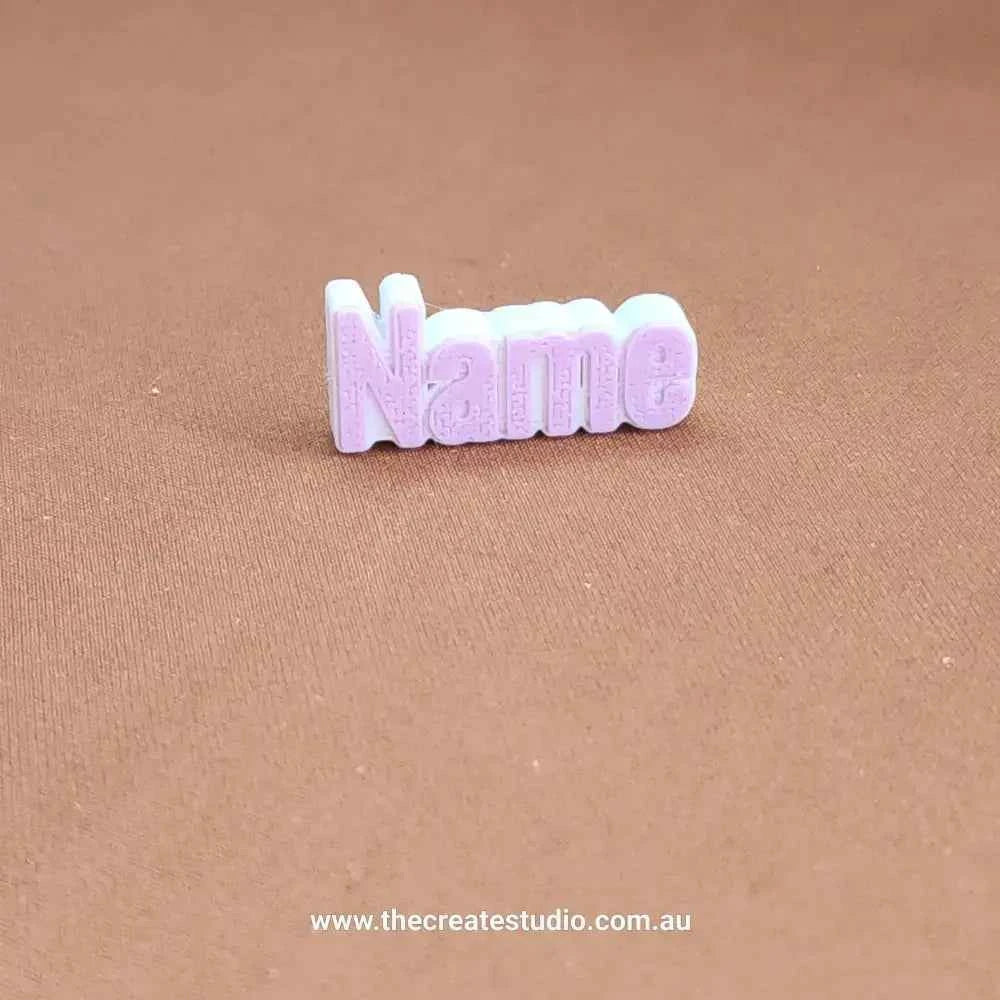 Personalized name charm for Crocs in purple, perfect for customizing footwear