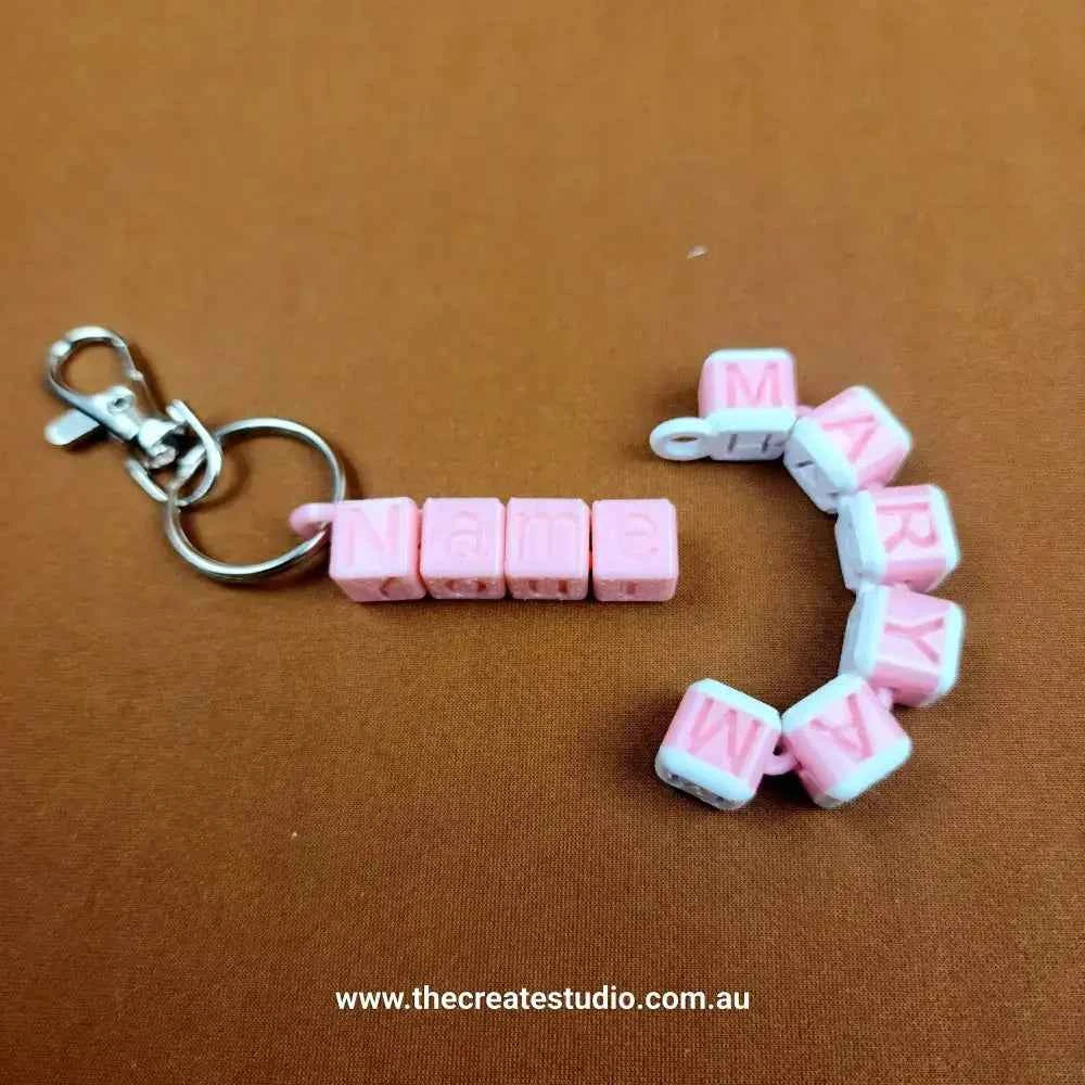 Personalised name keychain featuring pink and white letter beads spelling 'Mary' with a silver clasp
