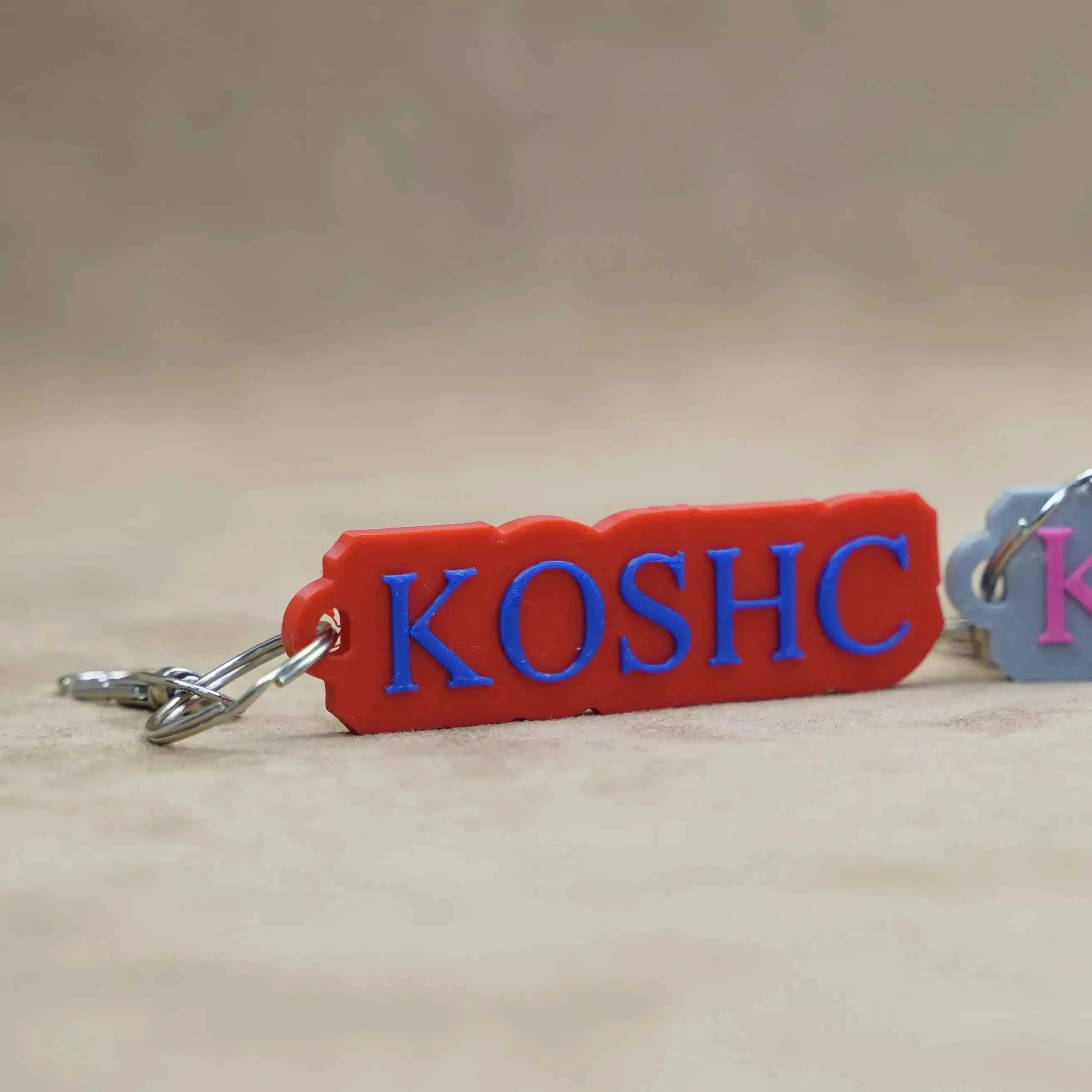 Custom font keychains featuring personalised text design in vibrant red and blue colours