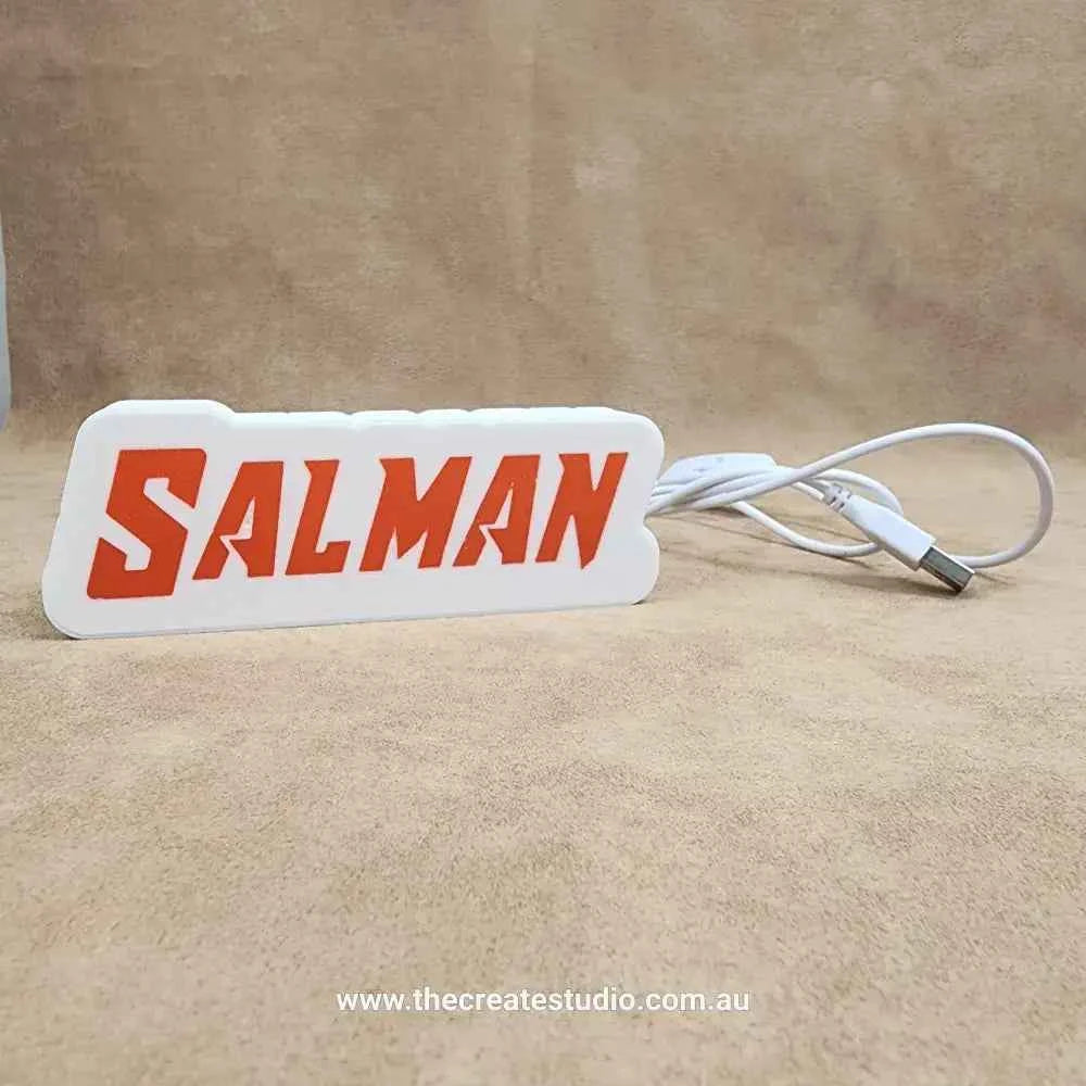 Custom gift light box in white with red lettering spelling SALMAN, ideal for personalized decor