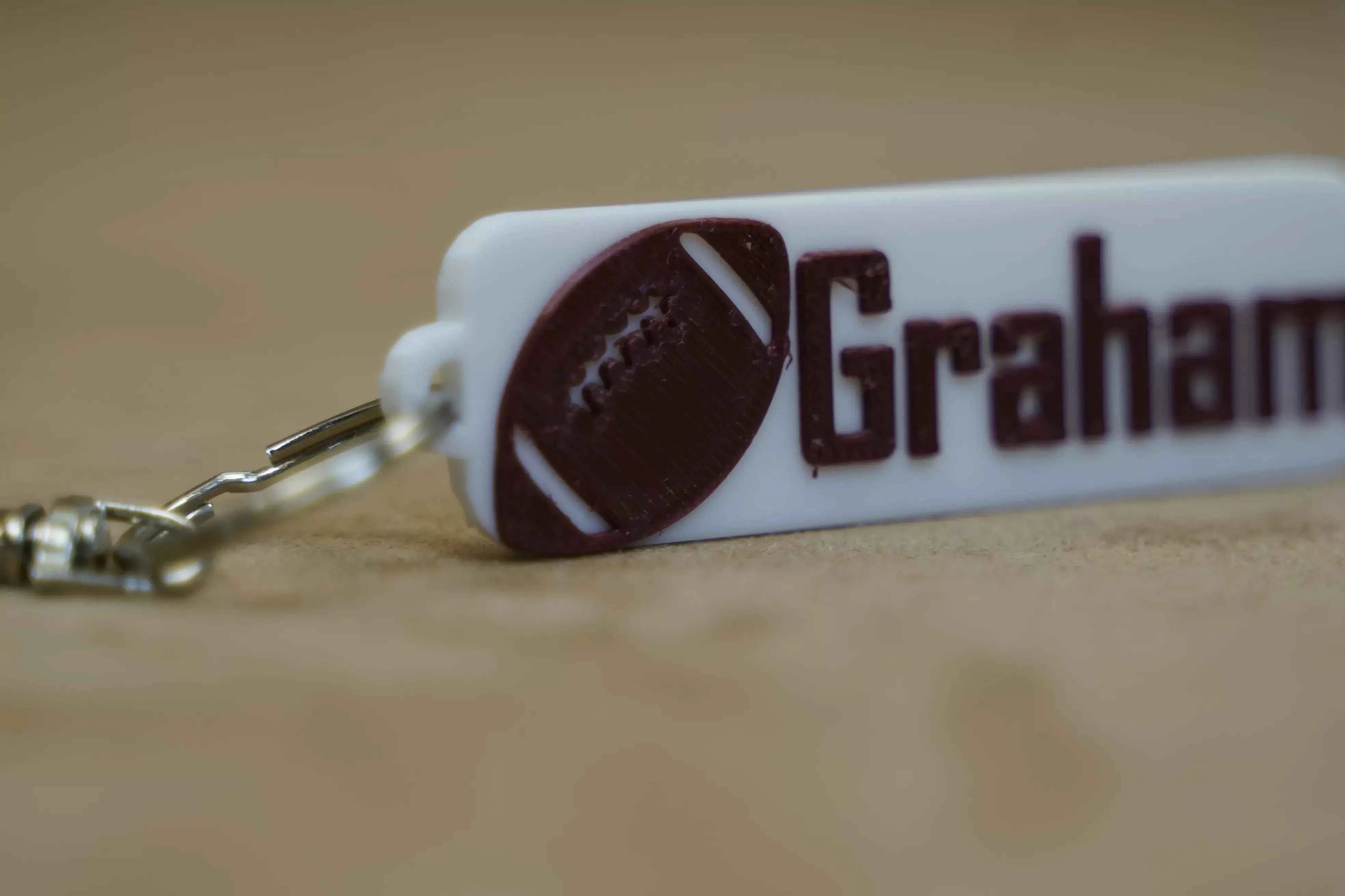 Custom name footy keyring featuring a football design and personalised name for sports enthusiasts