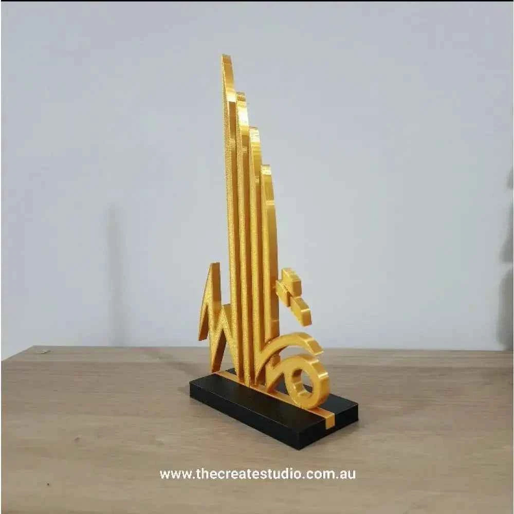 Gold Islamic calligraphy tabletop art sculpture on a black base, adding elegance to decor