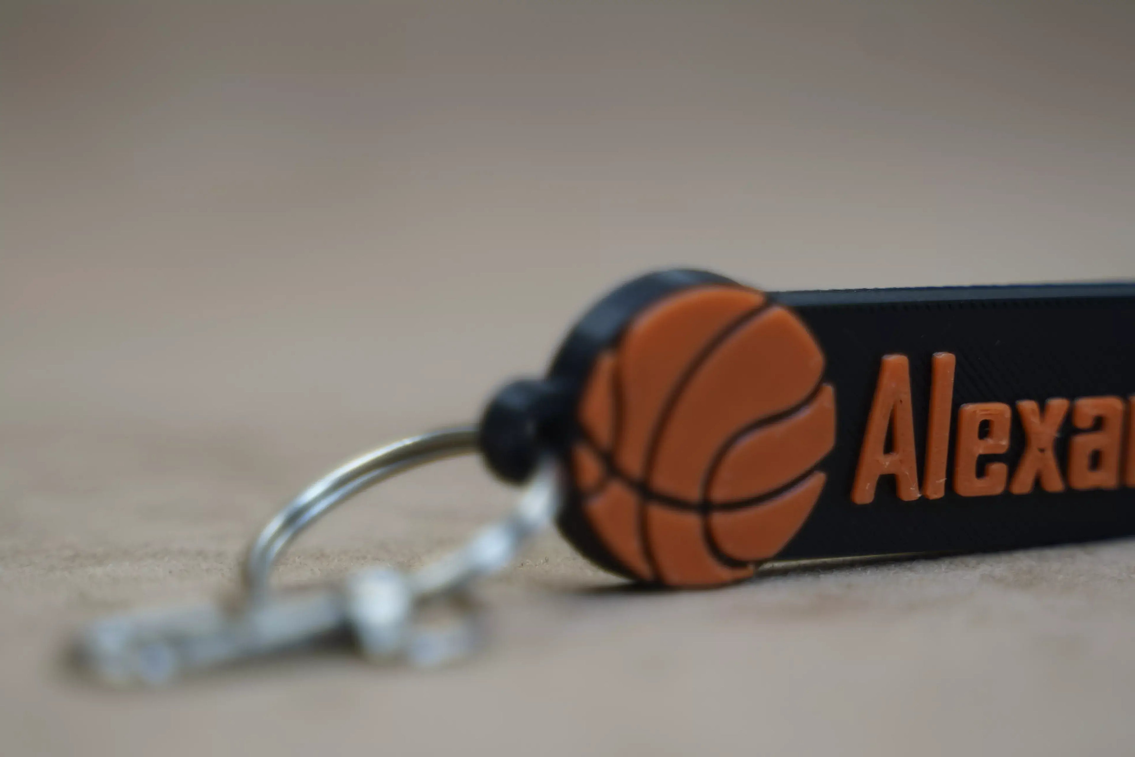 Personalised basketball keychain featuring a basketball design and custom name detail