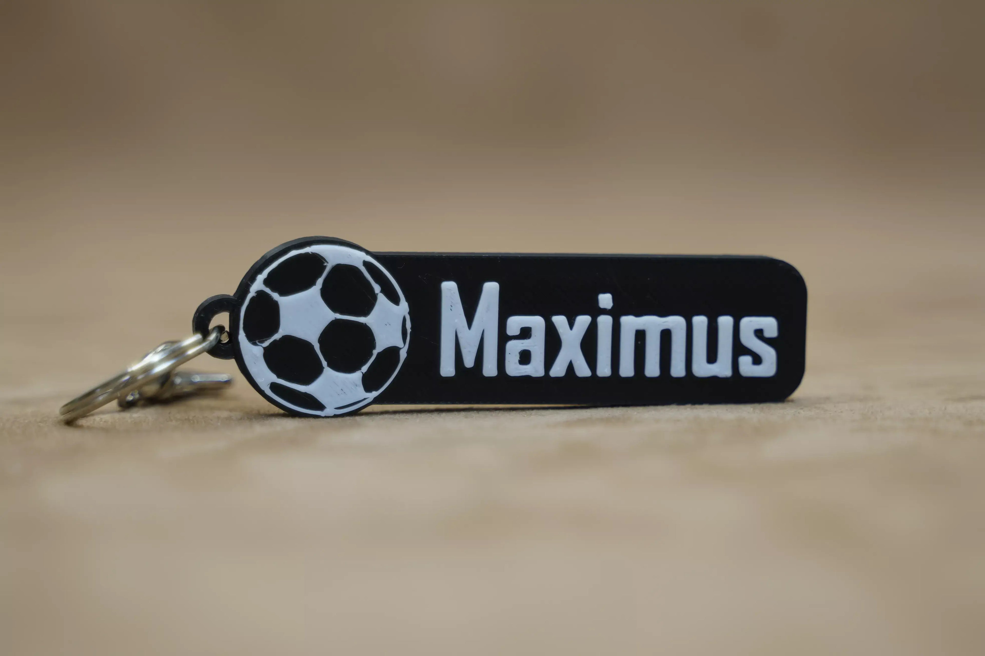 Personalised football keychain featuring a football graphic and the name Maximus