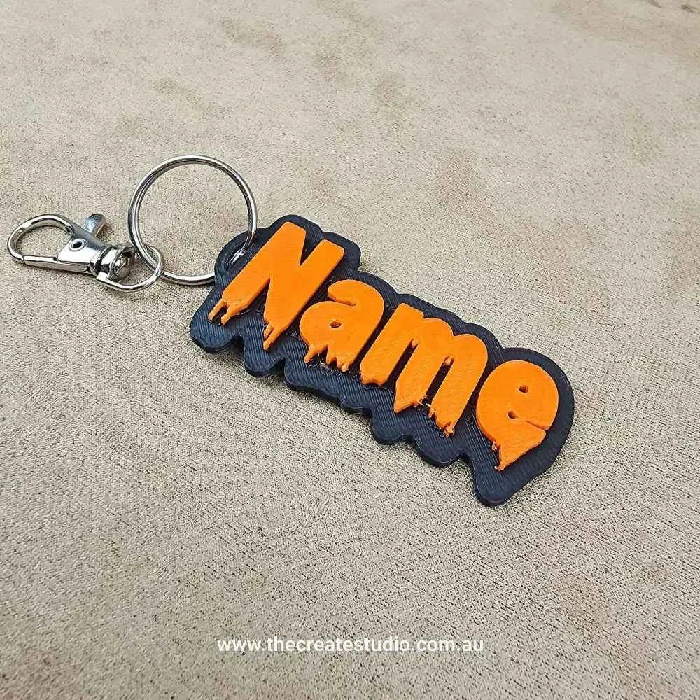 Personalised Halloween keychain in black and orange with custom name design
