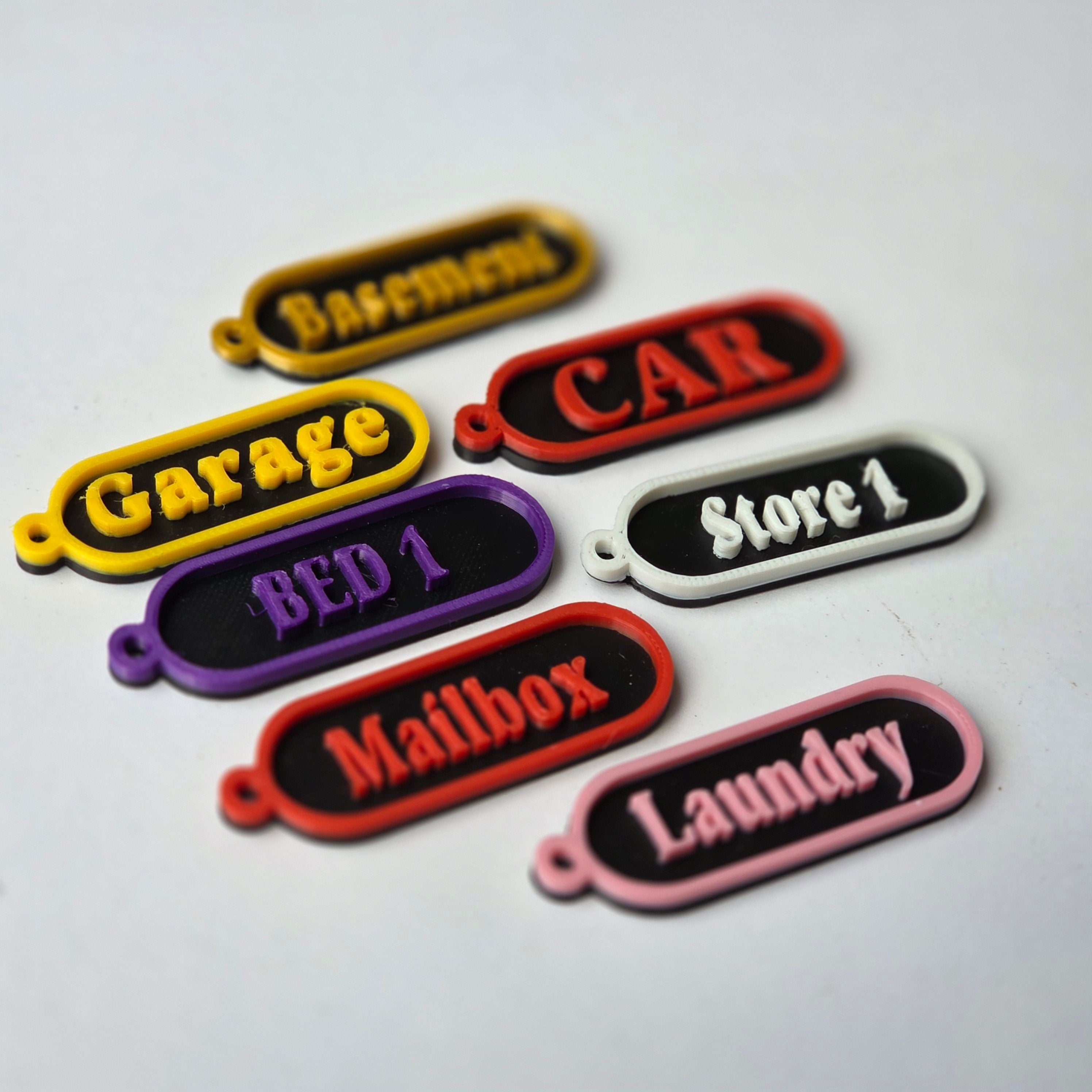 Colourful personalised keychain tags including labels for Garage, CAR, and Laundry for easy organisation