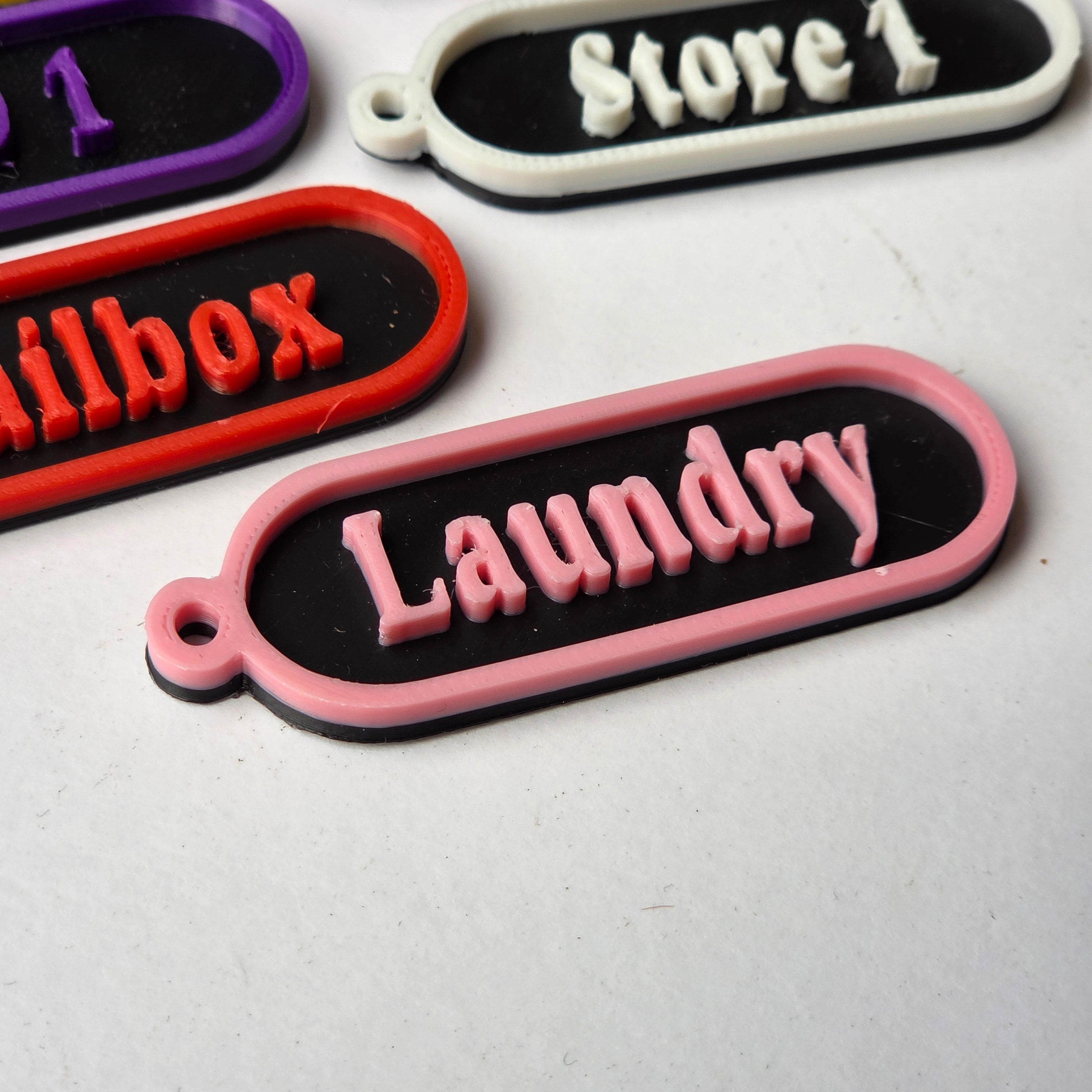 Colourful personalised keychain tags featuring labels like Laundry and Store 1 from The Create Studio