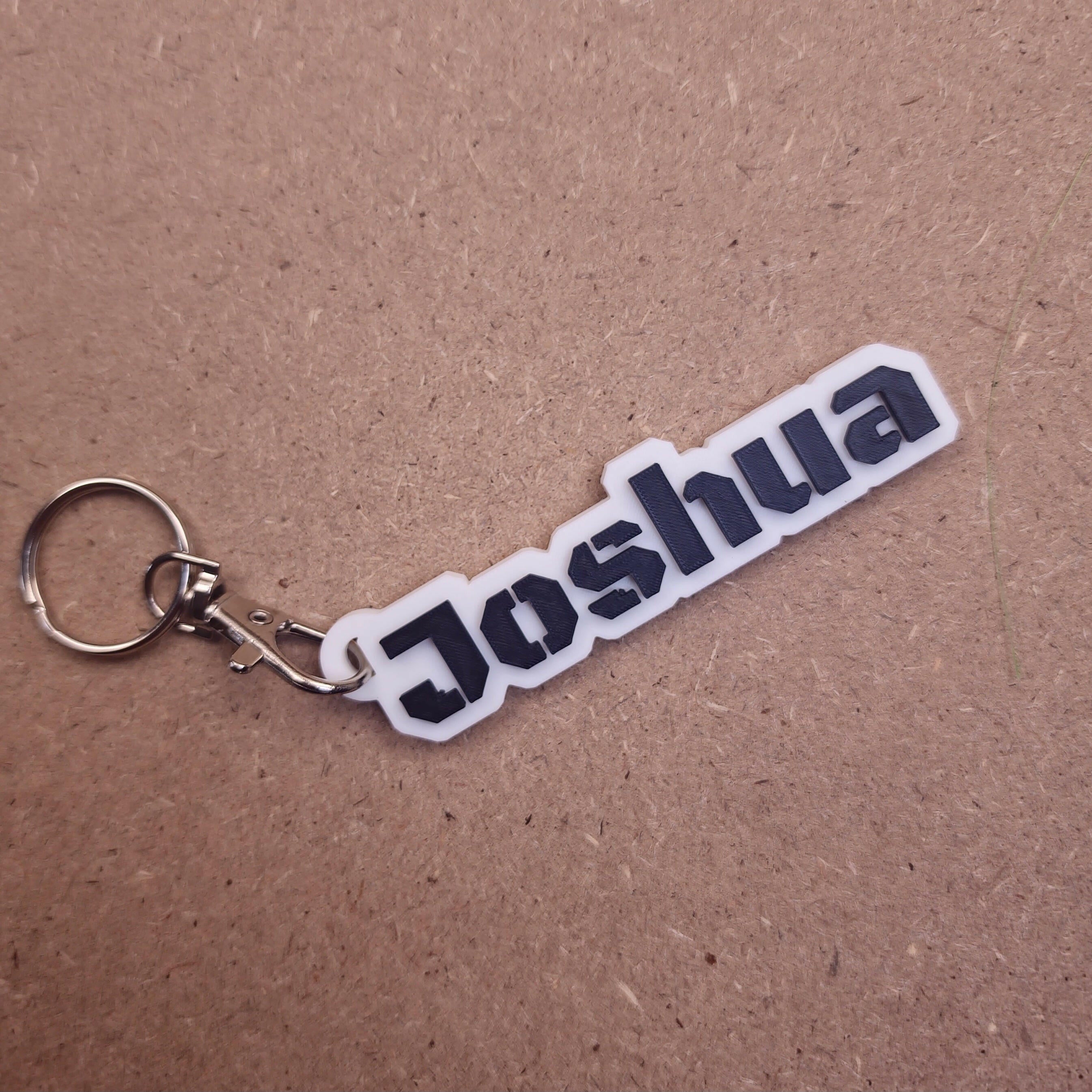Personalised keychains with modern fonts featuring the name Joshua in sleek design