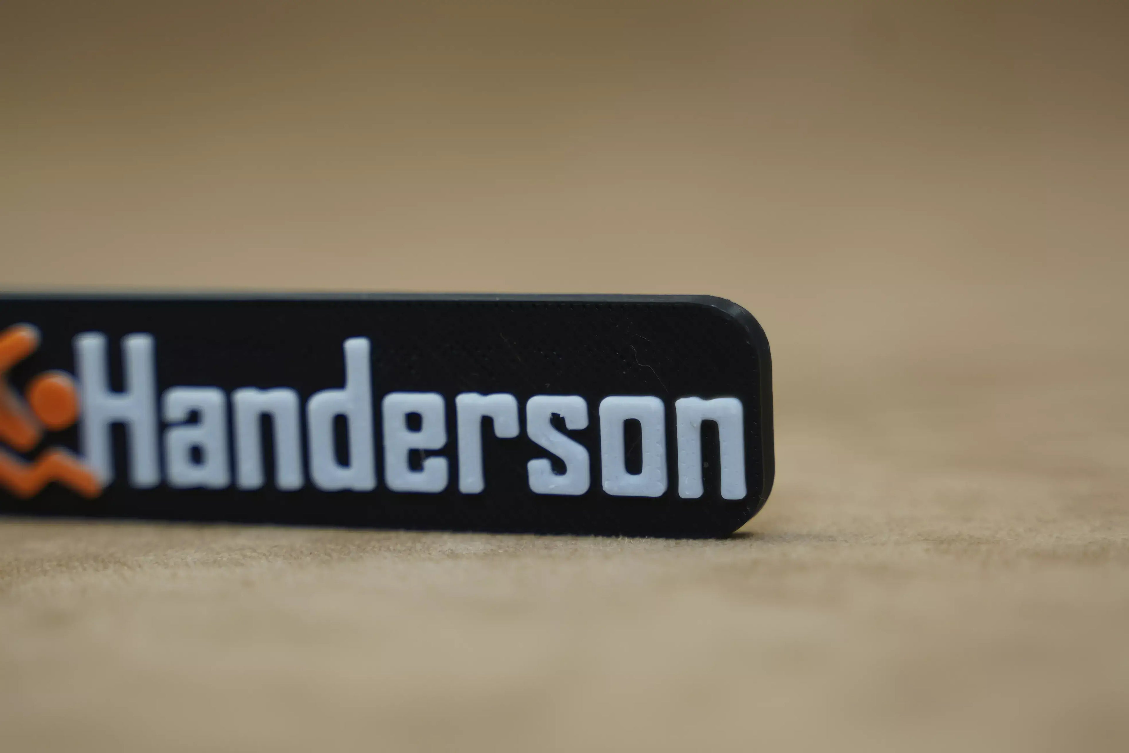 Customised black keychain featuring the name Henderson and swimmer icon, perfect as a personalised swimmer keychain