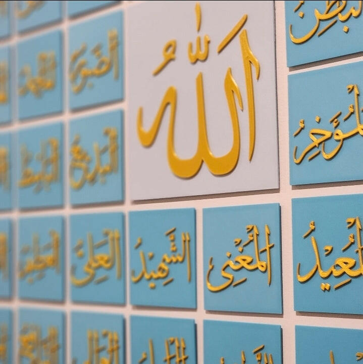 99 Names of Allah wall art by The Create Studio featuring gold Arabic calligraphy on blue and white tiles