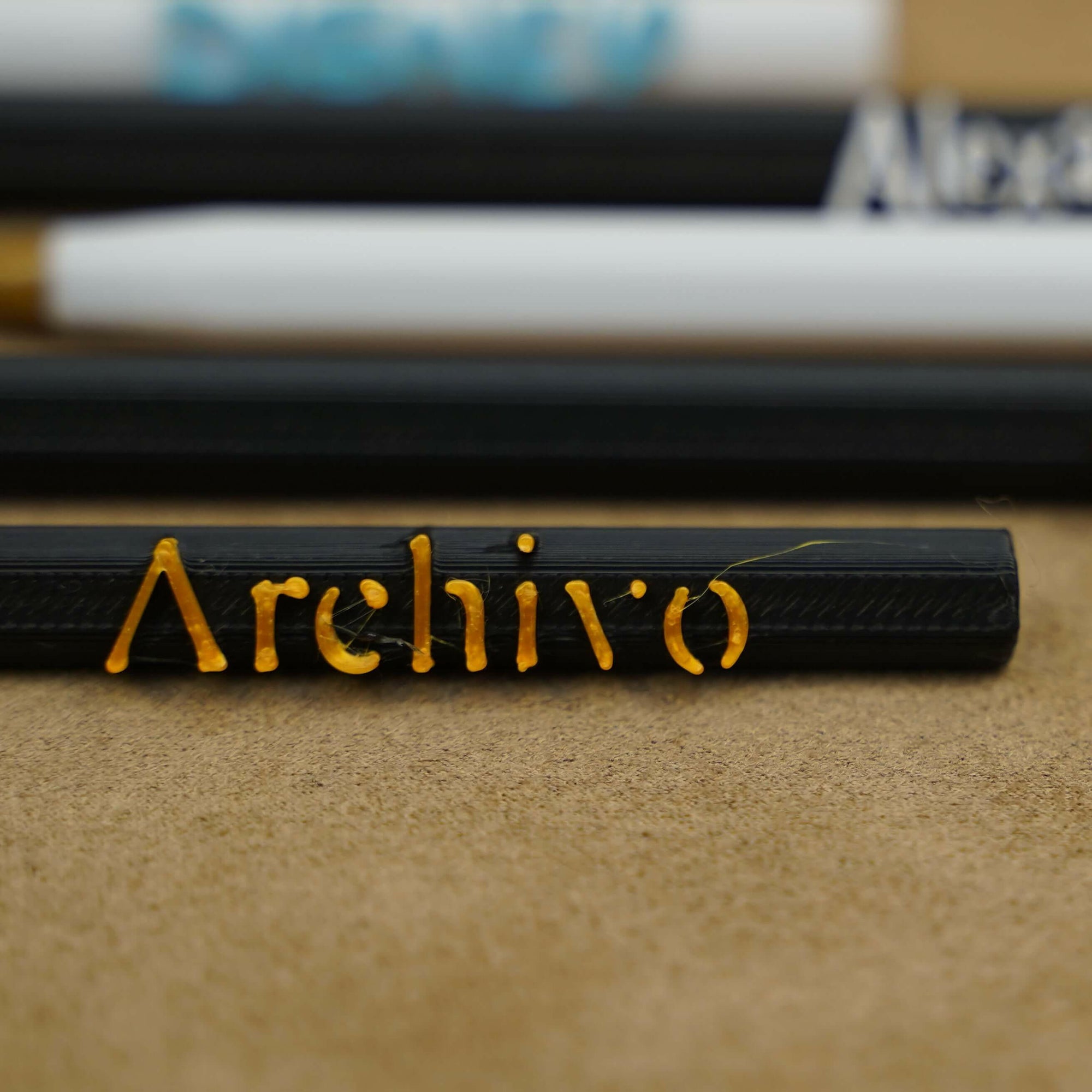 Close-up of personalized pens with names engraved, showcasing unique writing instruments in various colors.