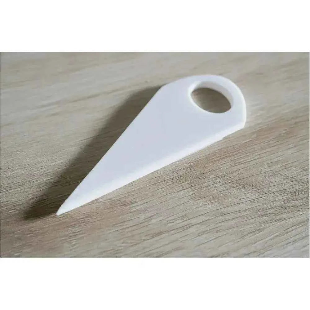 White bookbinding tool included in the complete bookbinding toolkit for precise paper handling