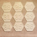 Cream hexagonal bee hive numbering plate set showing embossed numbers 28 to 36 in three rows