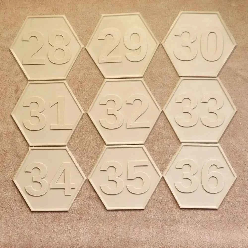 Cream hexagonal bee hive numbering plate set showing embossed numbers 28 to 36 in three rows