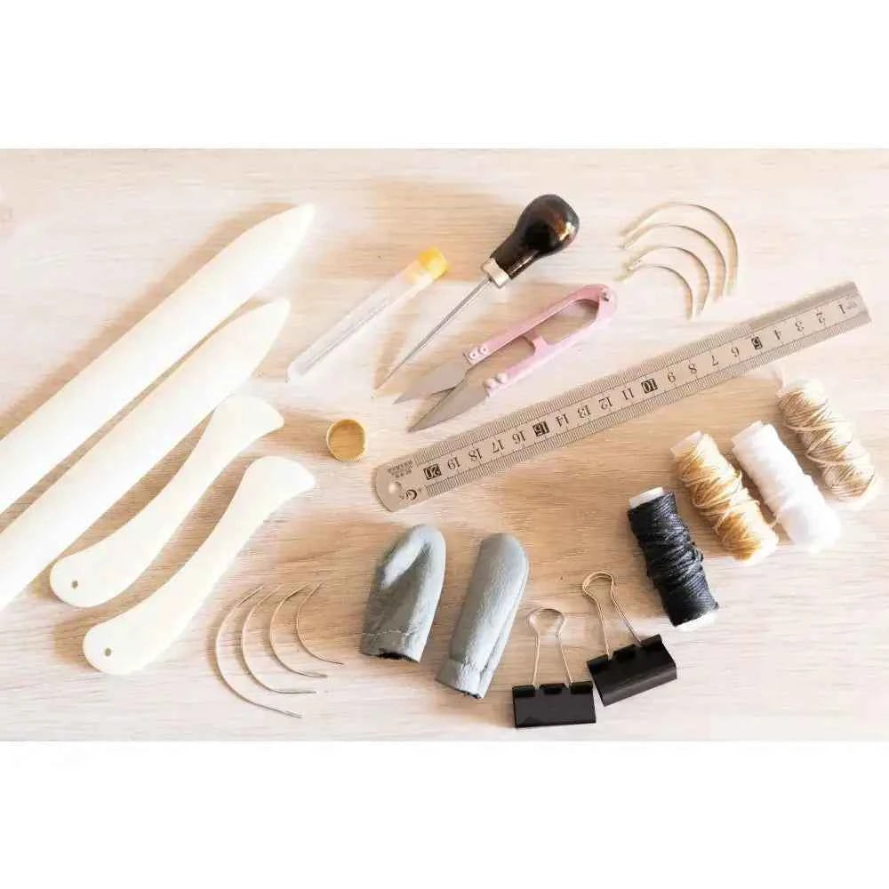 Complete book binding sewing set with tools, threads, needles, and a ruler for crafting handmade books