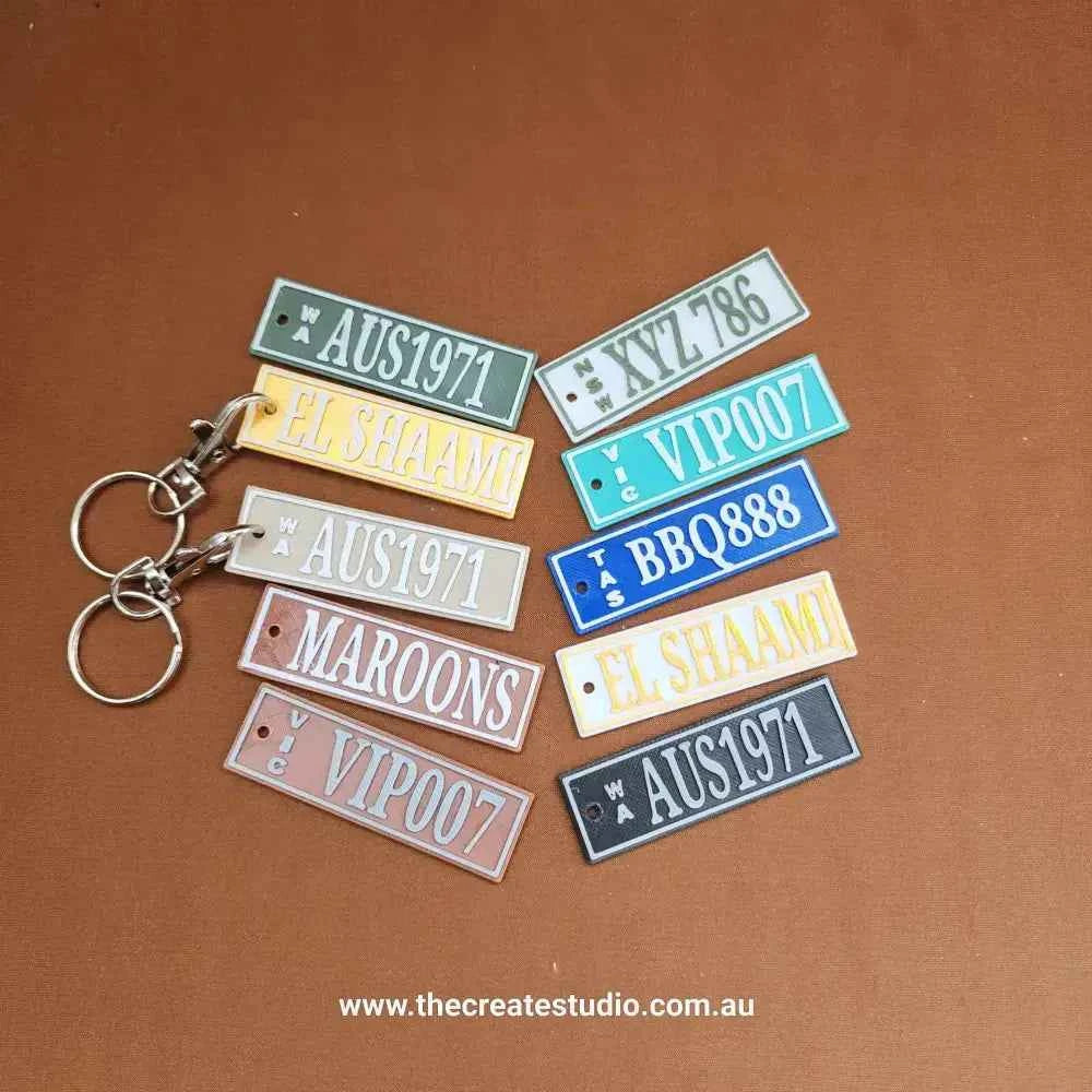 Colorful Car Rego Keychains from The Create Studio showcasing various designs and tags