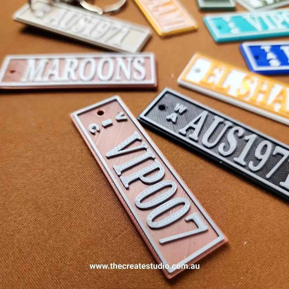 Variety of Car Rego Keychains in different colours and designs for personalising your keys