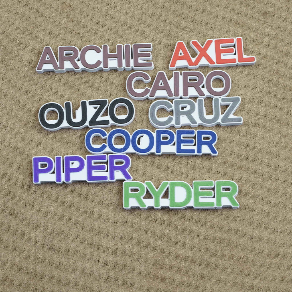 Colorful name charms for crocs including Archie, Axel, Cairo, and Ryder for personalized footwear