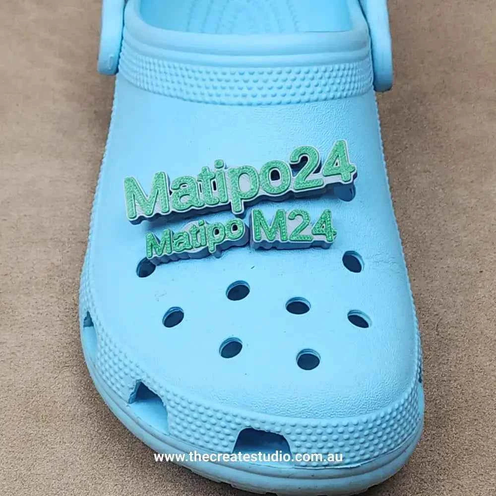 Personalized name charms for crocs in green on blue croc footwear from The Create Studio