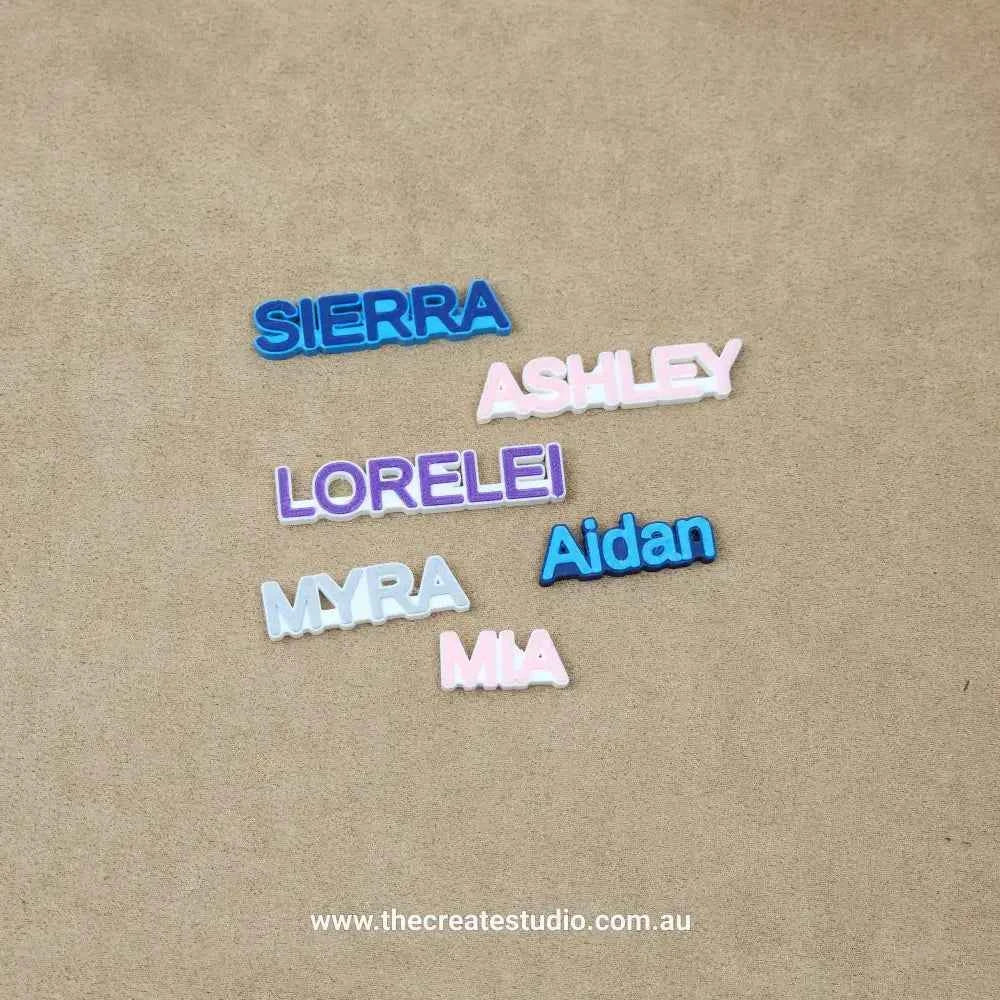 Personalized name charms for crocs in various colors including Sierra, Ashley, Lorelei, Myra, Aidan, and Mia