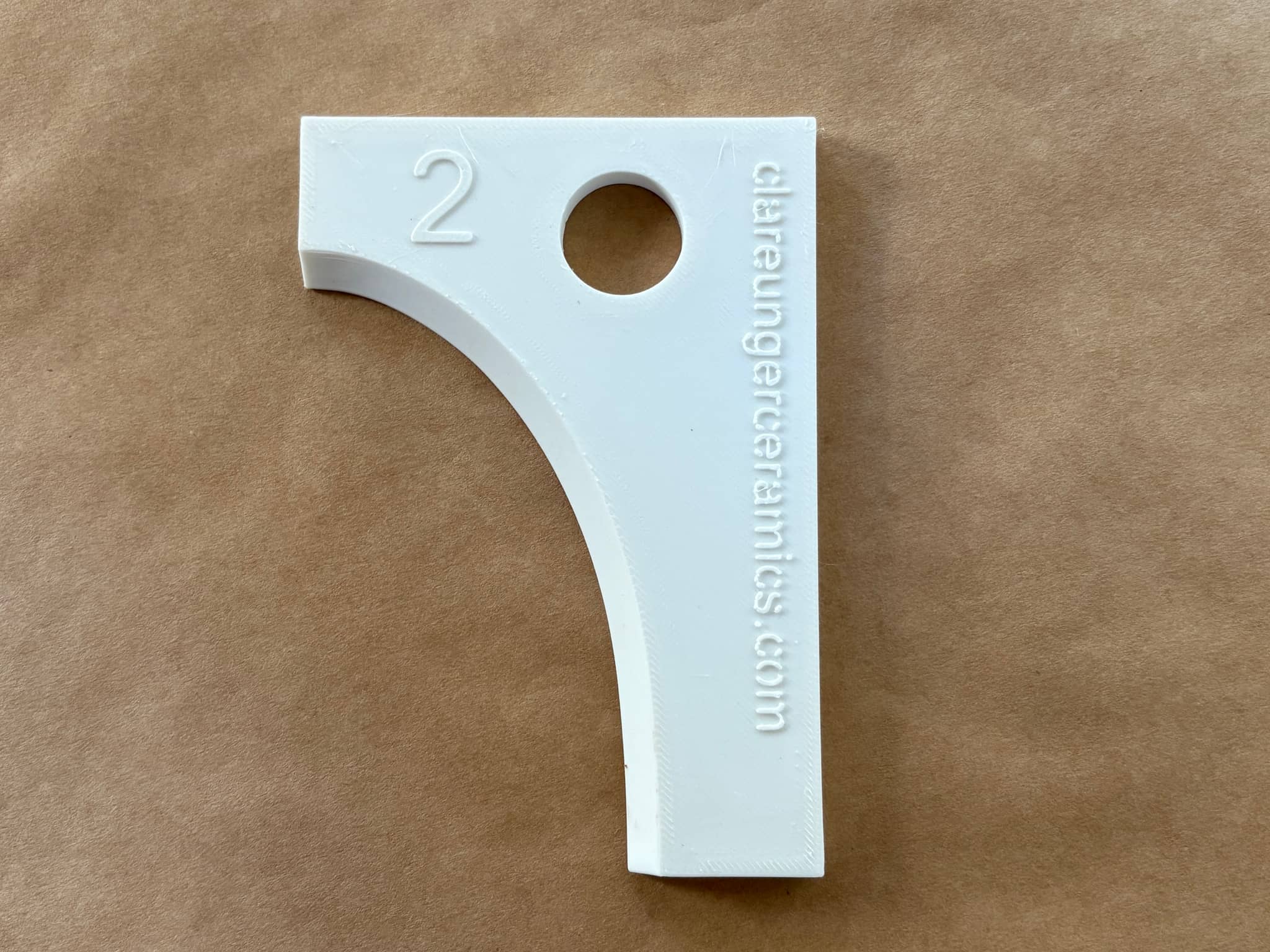 White ceramic template numbered 2, designed by Clare Unger for precise crafting projects