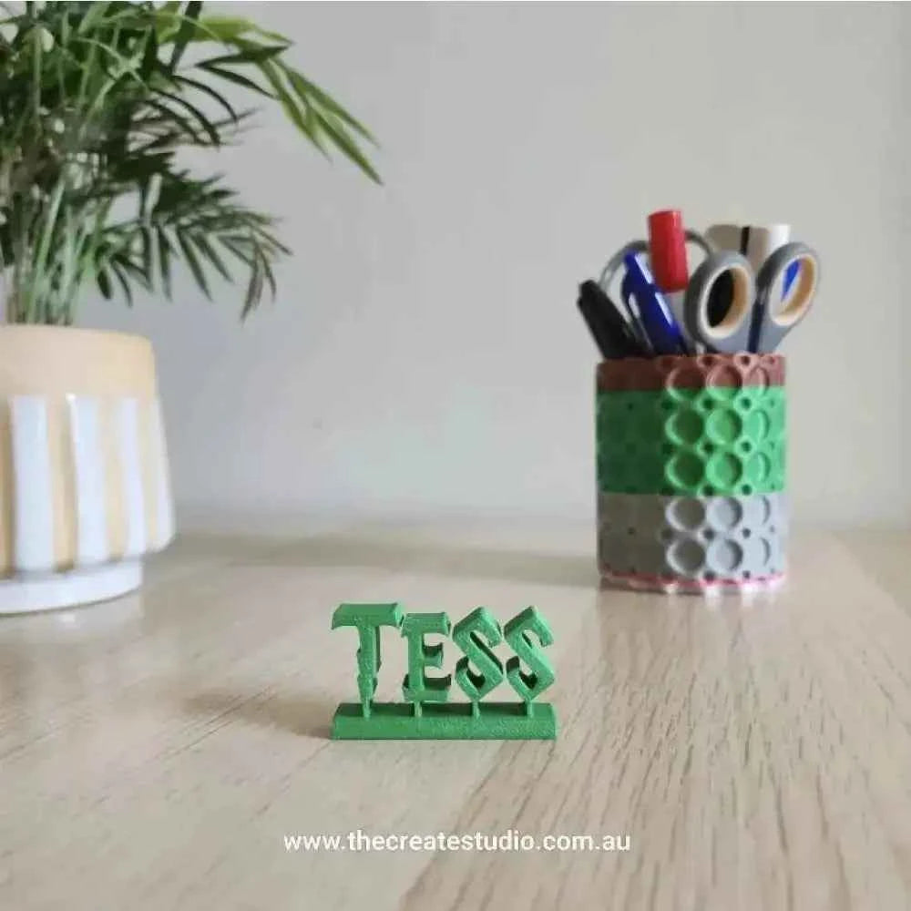 Harry Potter desk name plaque displayed on a desk with a plant and stationery holder