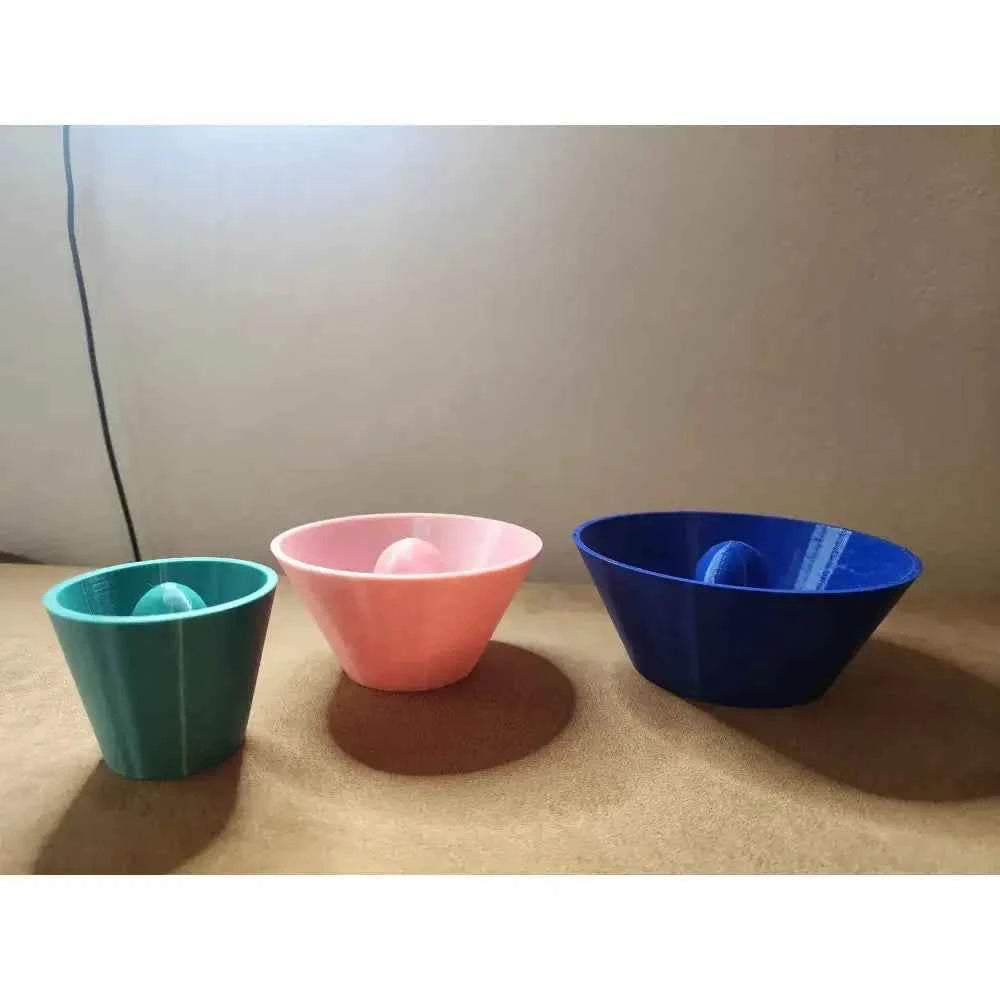 Set of three pottery shaping bowls in green, pink, and blue featuring a round rim pottery tool design