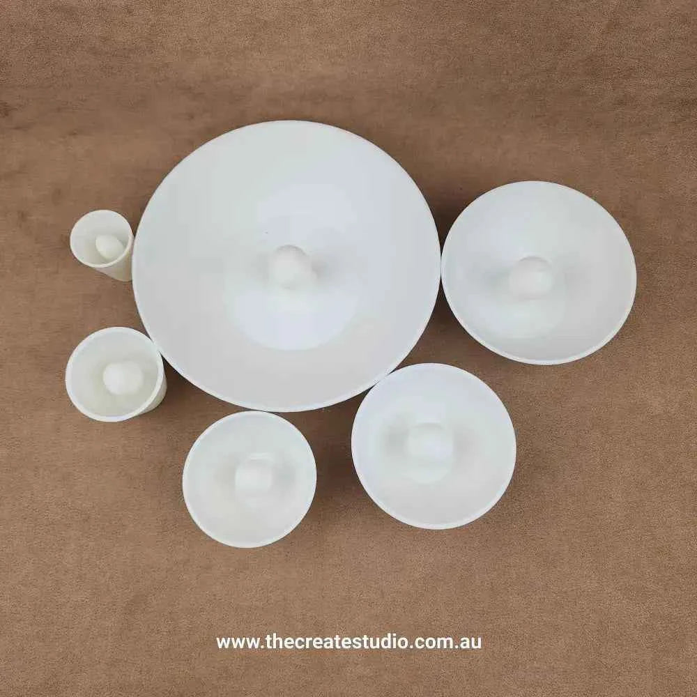 Set of white ceramics crafted with a round rim pottery tool for artists and potters