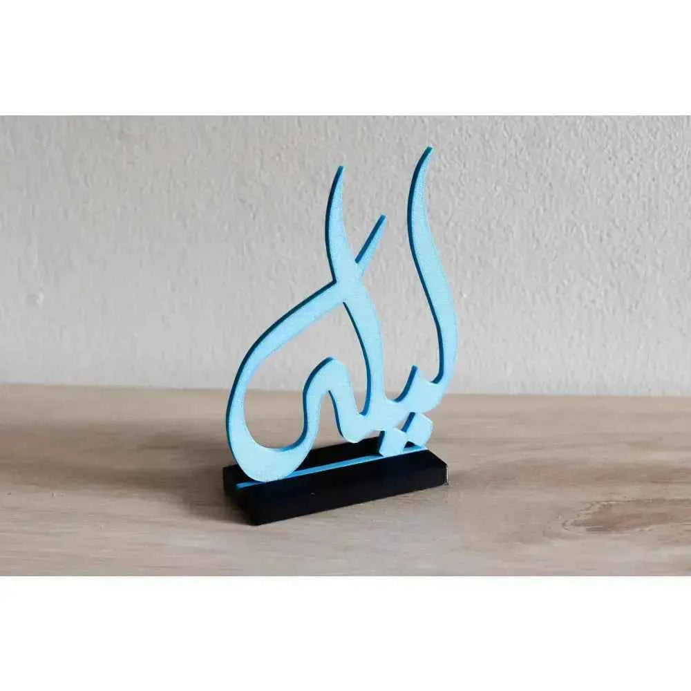 Custom Arabic name decor in blue standing on a sleek black base for personalized home decoration