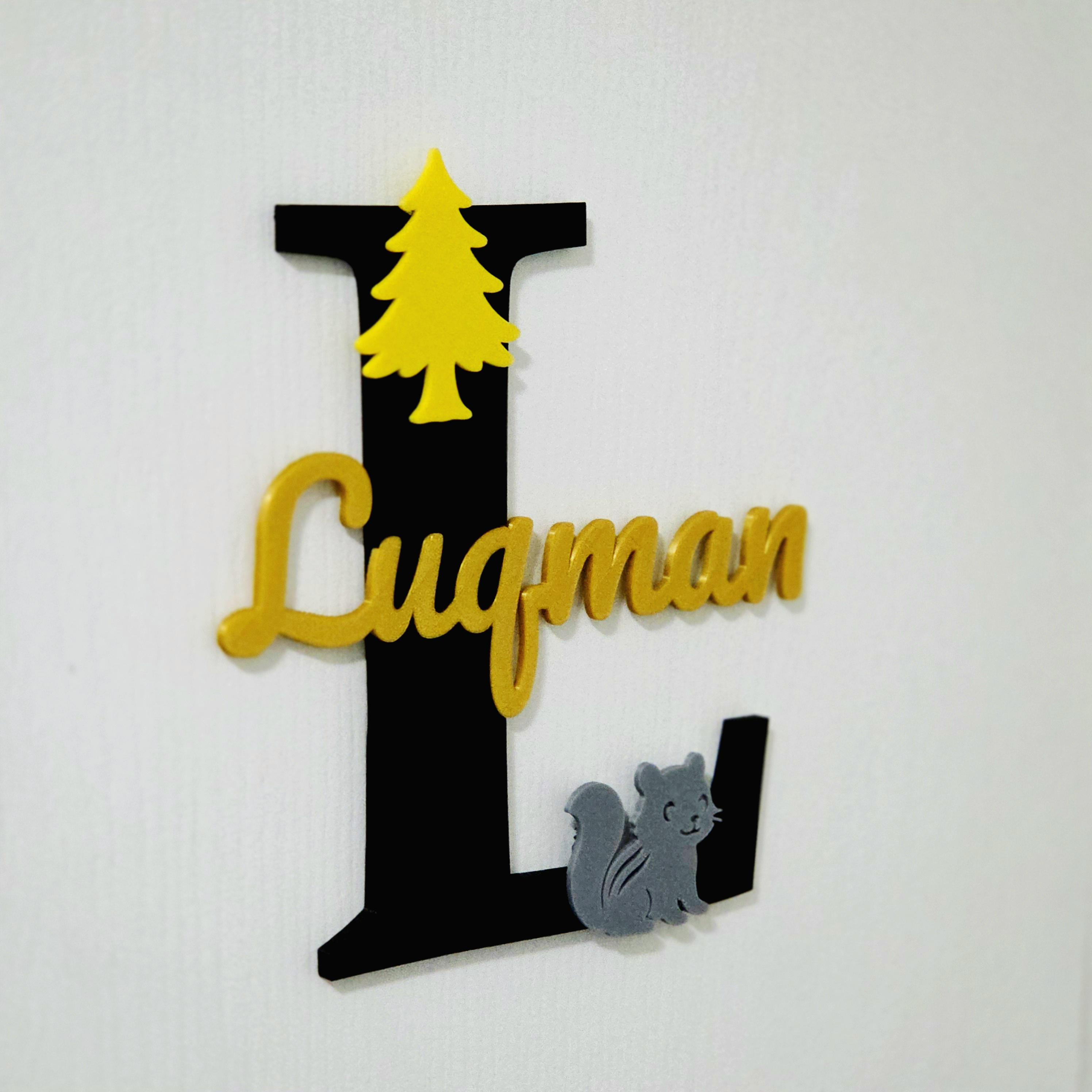 Custom baby room decor sign featuring a black letter L with a yellow tree and a grey squirrel