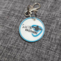 Custom keychain for companies featuring a blue and white design with swim logo and text