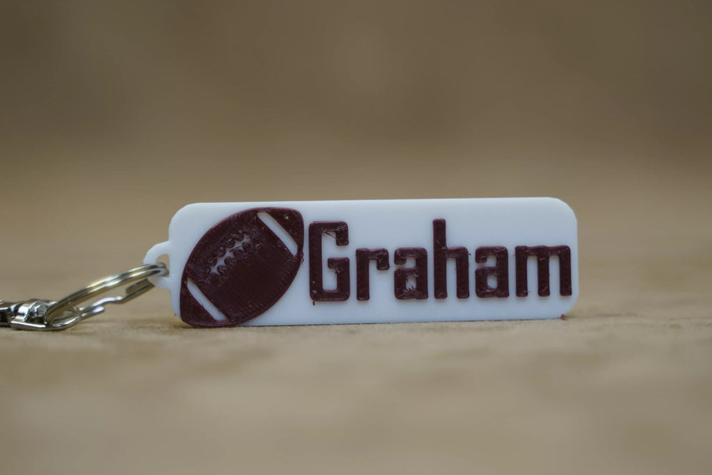 Custom name footy keyring featuring the name Graham with football design for sports enthusiasts