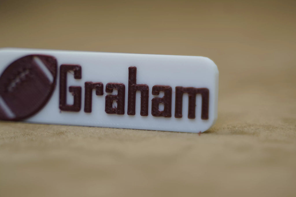 Custom name footy keyring with the name Graham and football design for personalised gifting