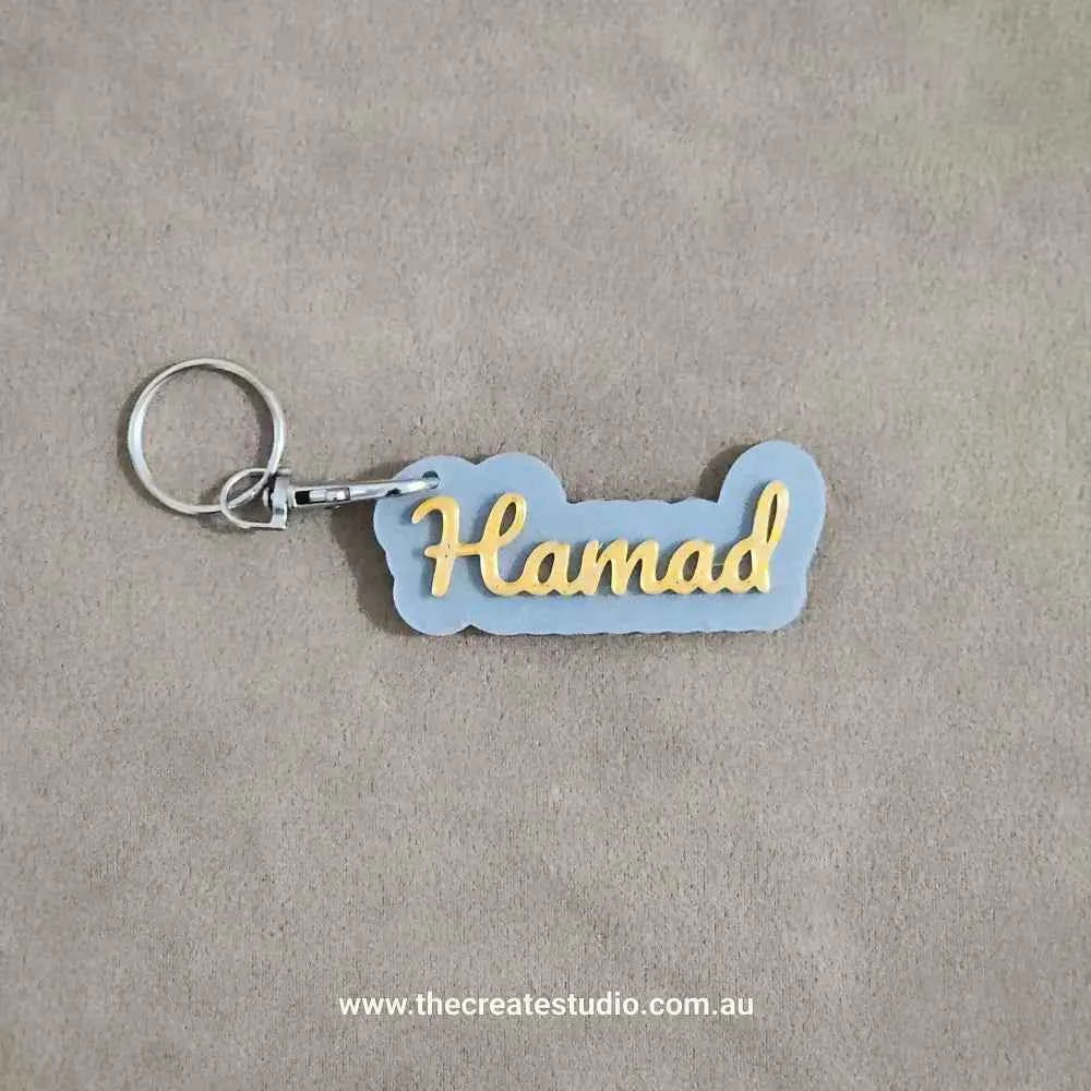 Custom name keychain in grey and yellow with the name Hamad for personalised gifting
