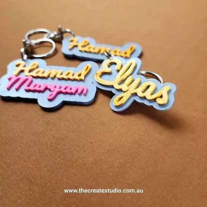 Custom name keychain set featuring colorful designs with names Hamad, Maryam, and Elyas