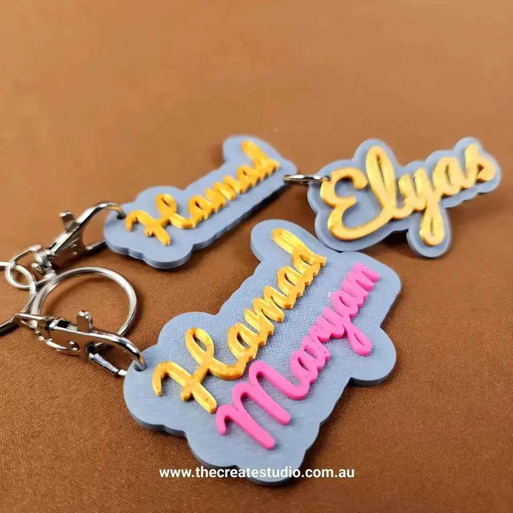 Custom name keychain featuring personalised names Hamad, Maryam, and Elyas in vibrant colours