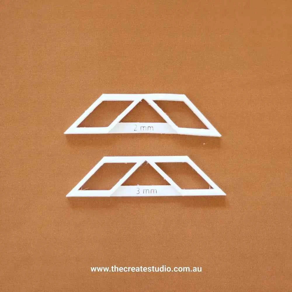 Essential bookbinding tools including white spine templates for precise book binding at 2mm and 3mm thickness