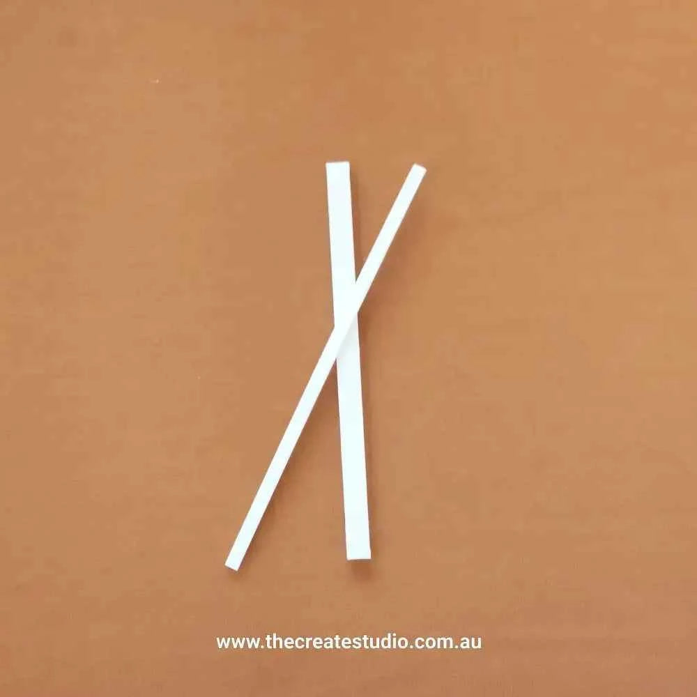 Essential bookbinding tools including smooth white bone folders for precise creasing and folding