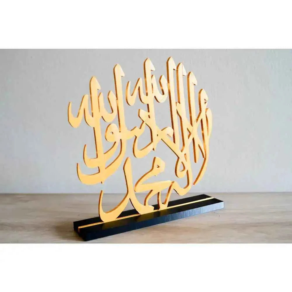 Stylish Islamic calligraphy table decor in gold with intricate designs and a sturdy black base