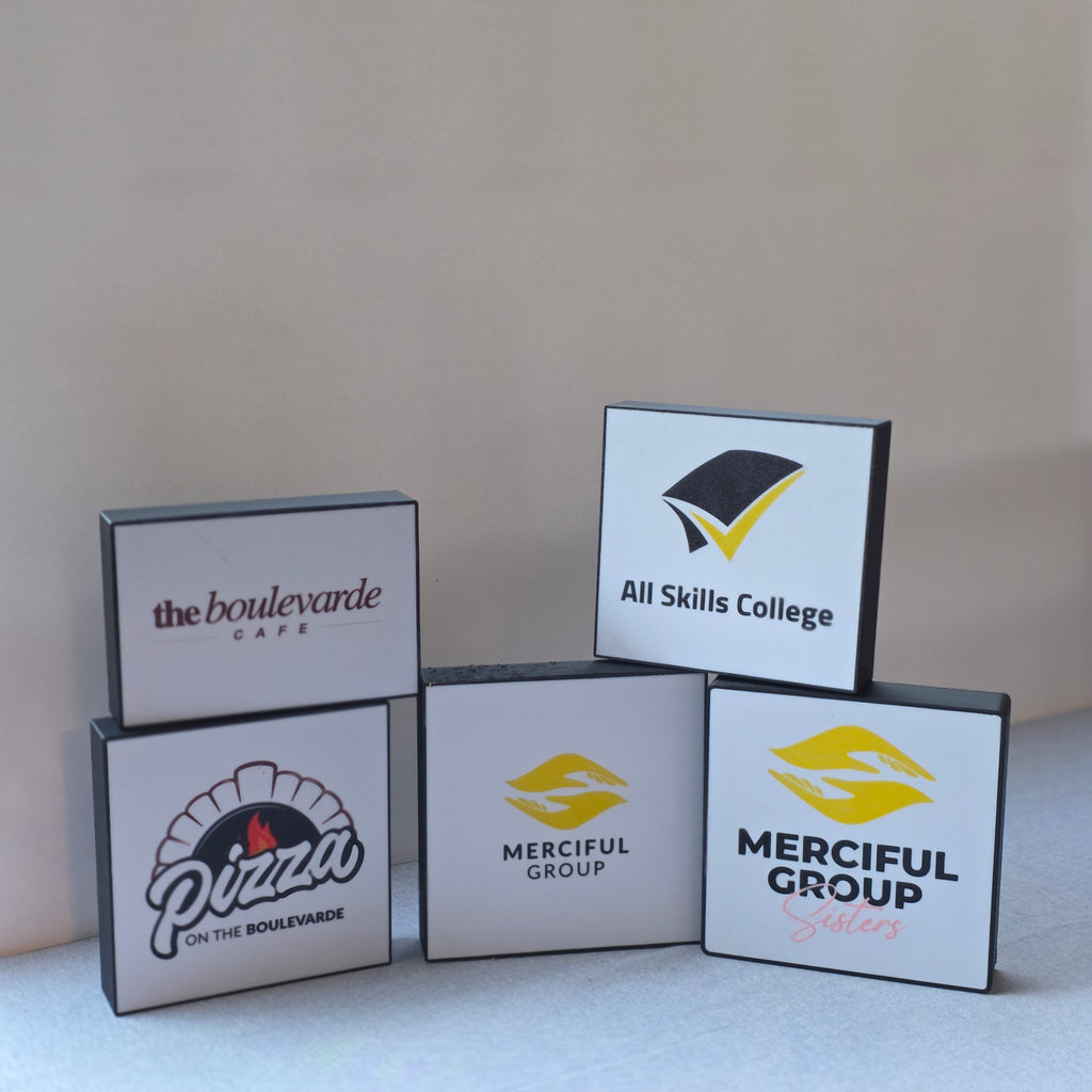 Stacked branded mini light boxes displaying company logos by The Create Studio unique corporate desk light box for office decor