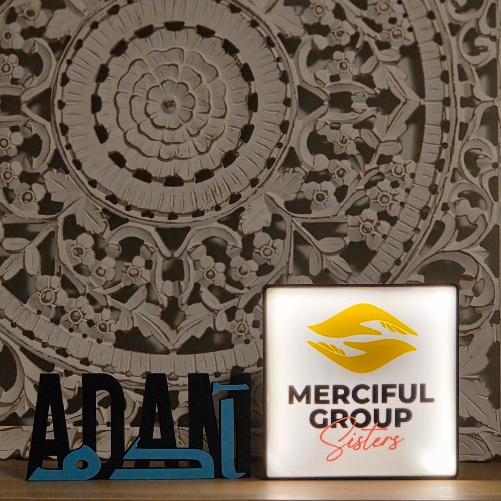The Create Studio unique corporate desk light box showing illuminated Merciful Group Sisters logo on carved decorative panel