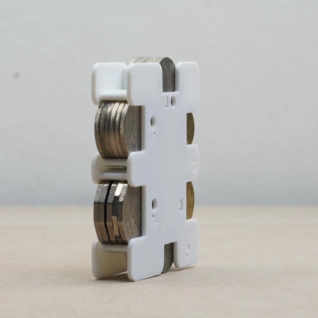 The Create Studio white plastic personal coin holder with stacked coins organiser for travel and pockets