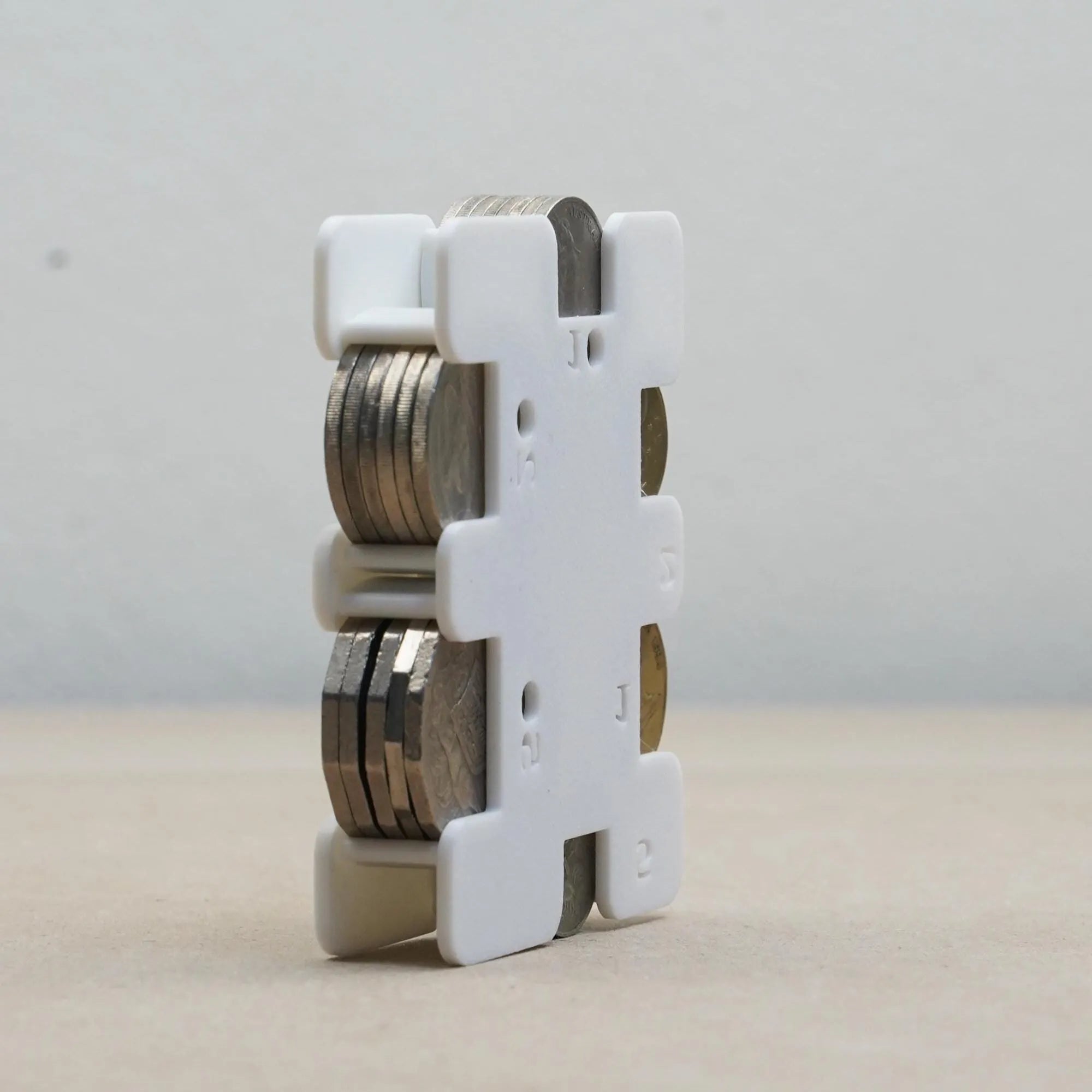 The Create Studio white plastic personal coin holder with stacked coins organiser for travel and pockets