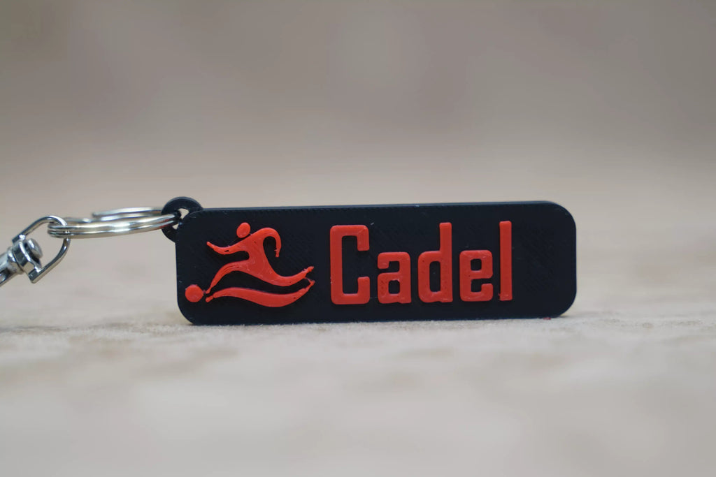Personalised football keychain featuring the name Cadel in bold red lettering