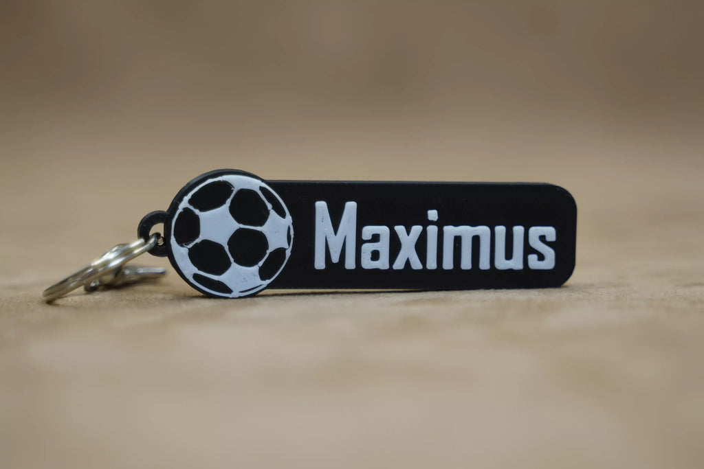 Personalised football keychain featuring a football graphic and the name Maximus