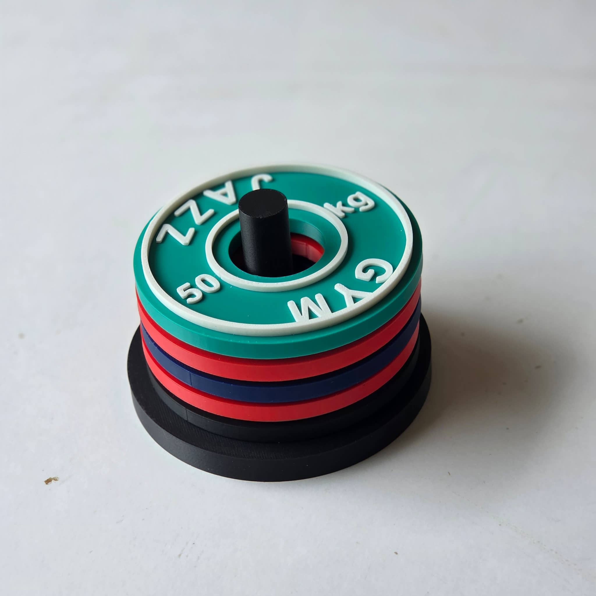 Colourful gym weight plate for personalised gym coasters featuring 50 kg with GYM and JAZZ text