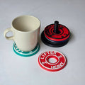 Personalised gym coasters shaped like weight plates in red, green, and black for fitness enthusiasts