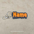Personalised Halloween keychain featuring a customisable name in orange and black design